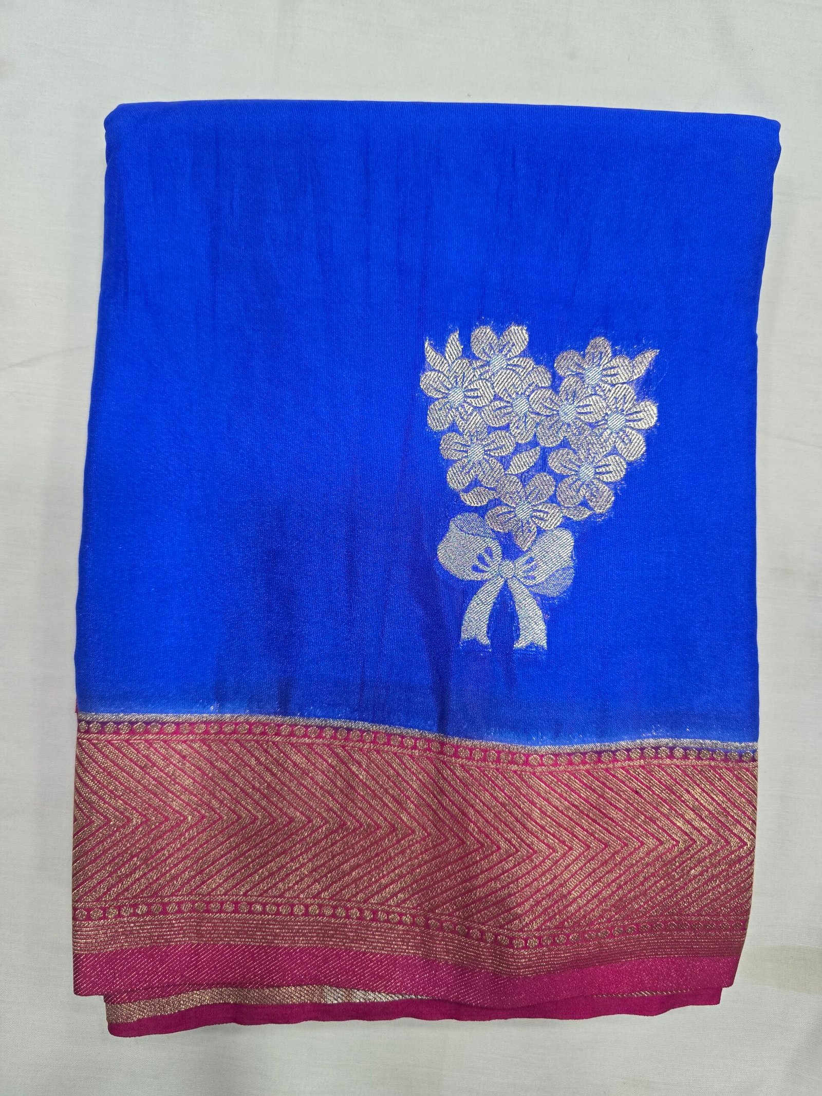 Soft Silk Saree, blue fabric with a gold floral motif and contrasting border.