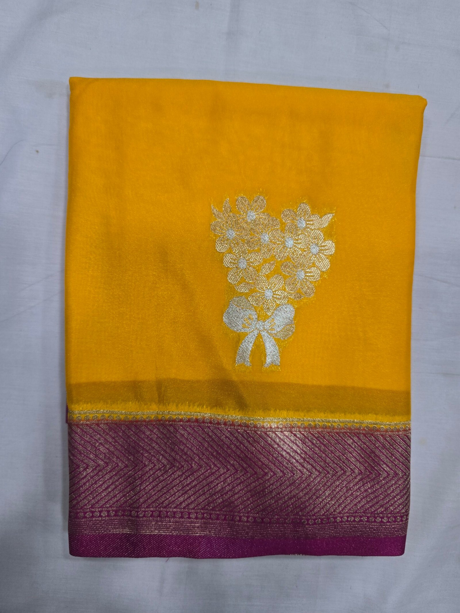 Soft Silk Saree, mustard yellow fabric with a gold motif and maroon border.