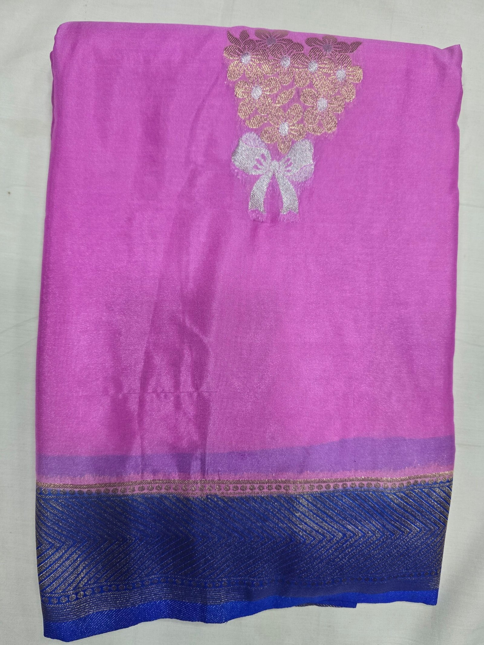 Soft Silk Saree, pink fabric with a gold floral motif and blue border.